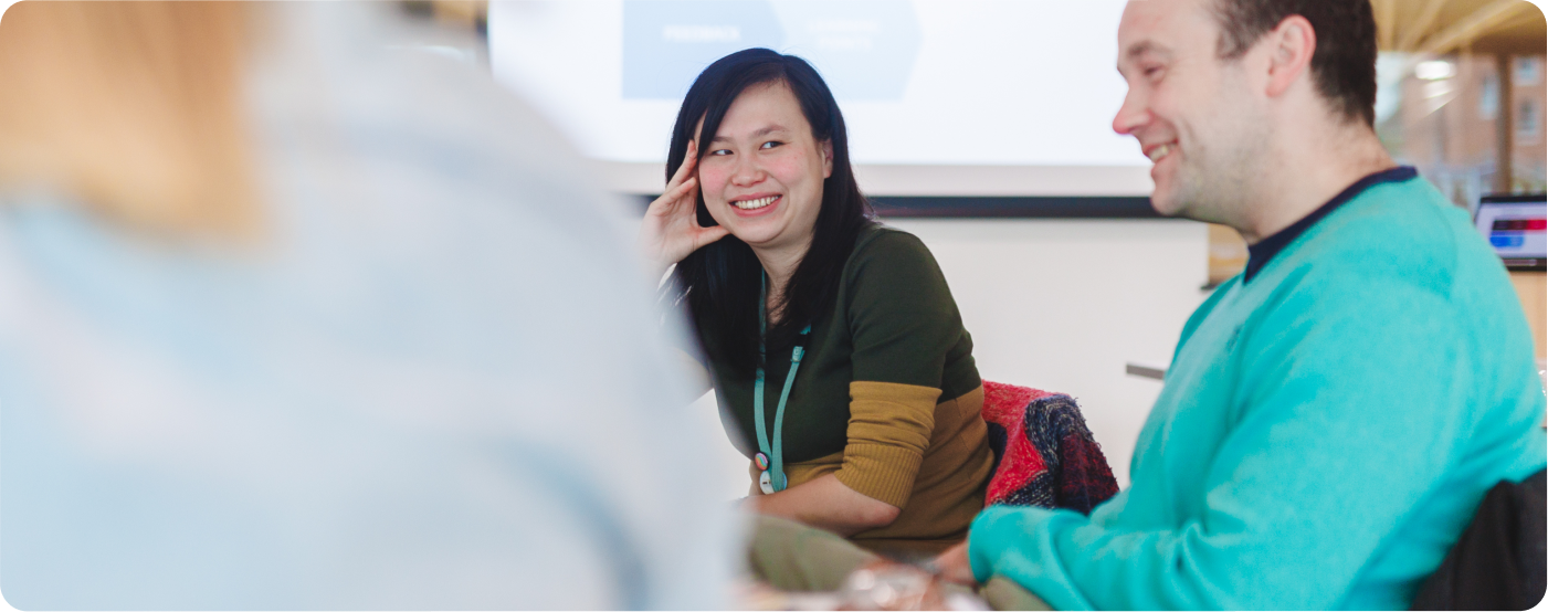 Lady smiling in class at male student