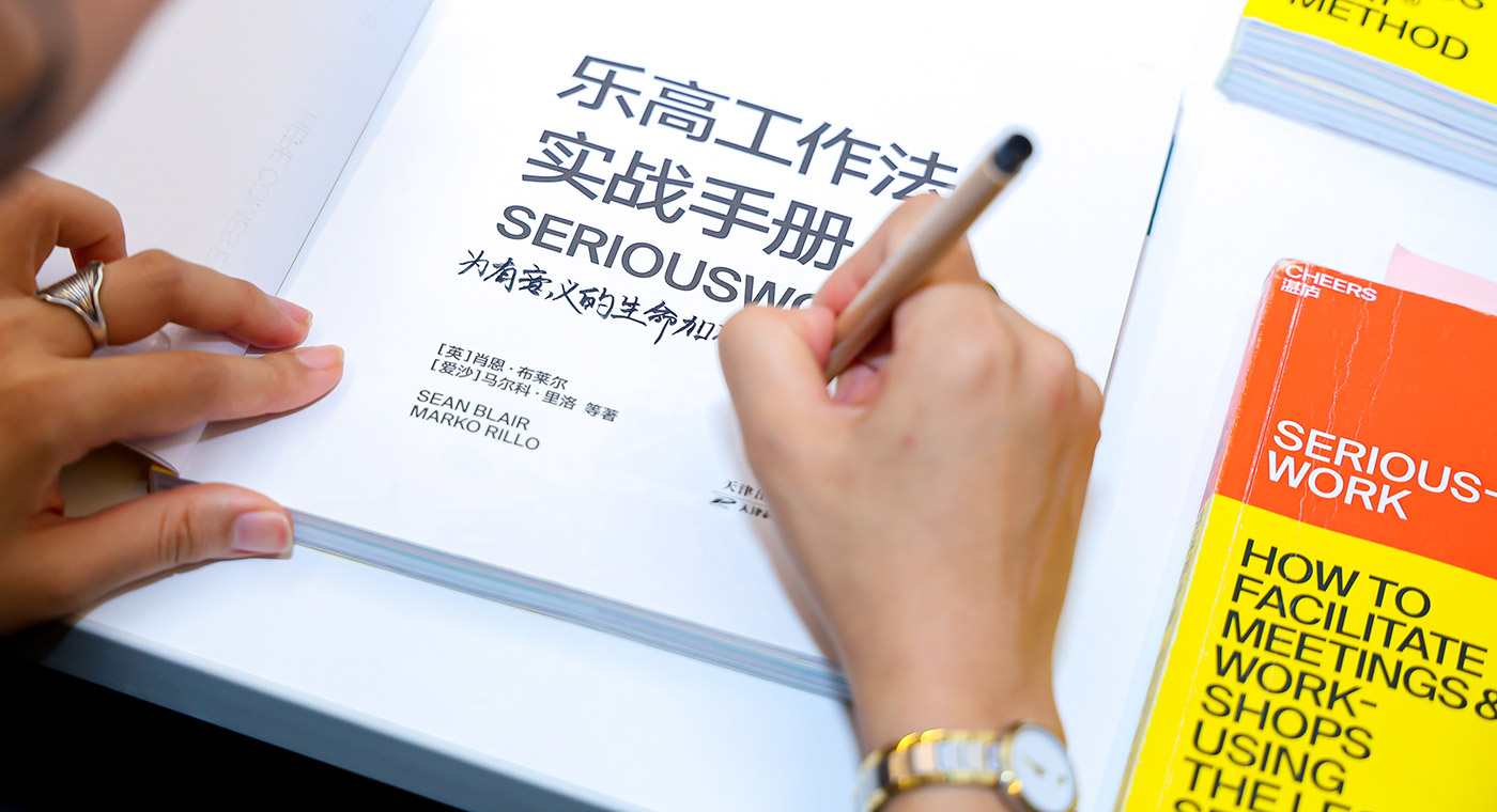 Lady smiling in class at male student